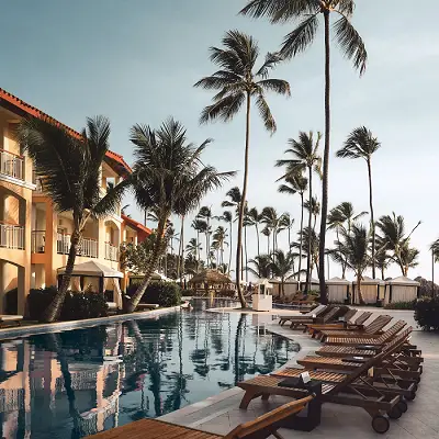 a hotel pool with palm trees